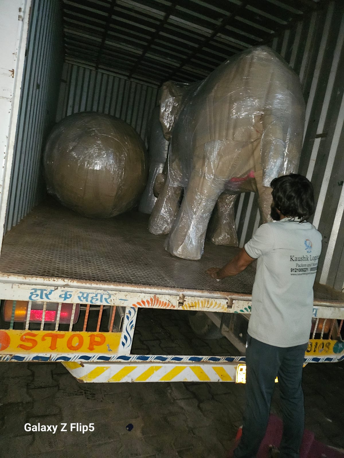 Kaushik Logistics container truck on the highway for an intercity relocation